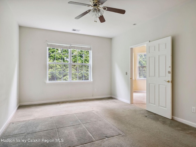 212 Commons Ln, Saugerties, NY 12477 - carpeted empty room with plenty of natural light, ceiling fan, and baseboards