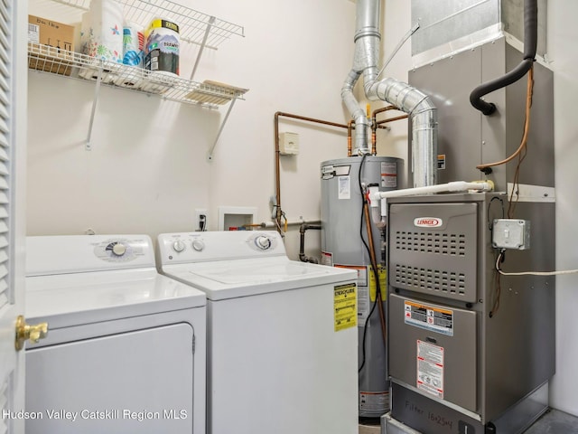 212 Commons Ln, Saugerties, NY 12477 - clothes washing area featuring washing machine and clothes dryer, water heater, and heating unit