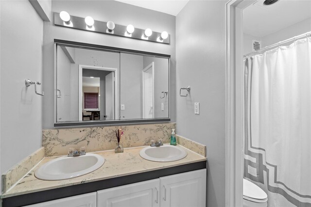 80 E Hartsdale Ave Unit 520, Hartsdale, NY 10530 - bathroom with double vanity, toilet, and curtained shower