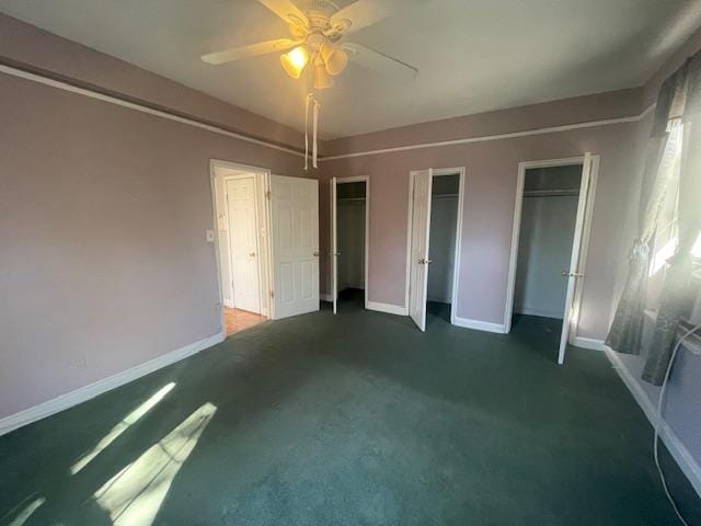 230 Central Ave Unit 2-H, Lawrence, NY 11559 - unfurnished bedroom with multiple closets, carpet, and baseboards