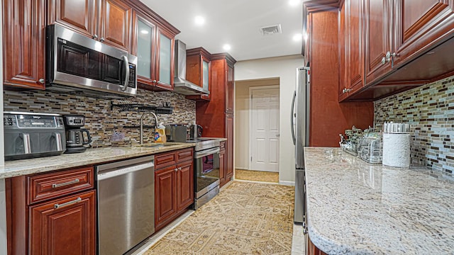 871 Val Park Ave, Valley Stream, NY 11580 - kitchen featuring appliances with stainless steel finishes, a sink, backsplash, wall chimney range hood, and light stone countertops