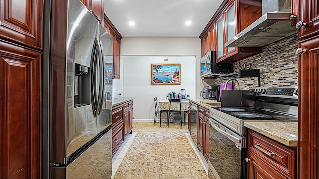 871 Val Park Ave, Valley Stream, NY 11580 - kitchen featuring stainless steel appliances, wall chimney exhaust hood, dark brown cabinets, tasteful backsplash, and light stone counters