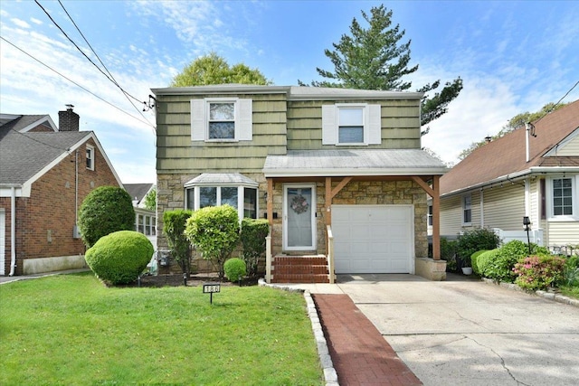 186 E Chester St, Valley Stream, NY 11580 - view of front of property with stone siding, a front lawn, concrete driveway, and a garage