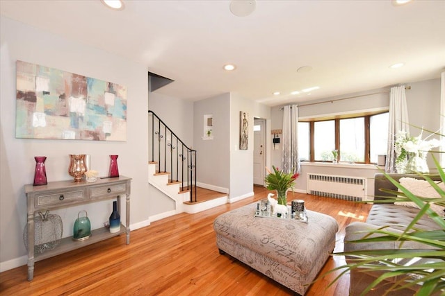 186 E Chester St, Valley Stream, NY 11580 - living area with radiator heating unit, light wood finished floors, stairway, recessed lighting, and baseboards