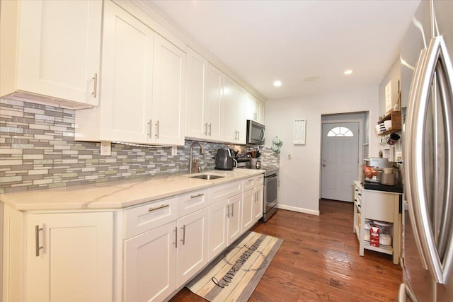 186 E Chester St, Valley Stream, NY 11580 - kitchen featuring appliances with stainless steel finishes, a sink, backsplash, white cabinetry, and recessed lighting