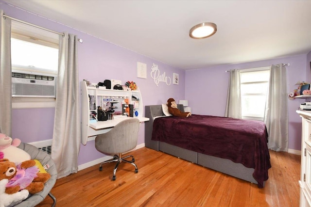 186 E Chester St, Valley Stream, NY 11580 - bedroom with multiple windows, light wood-style floors, cooling unit, and a desk