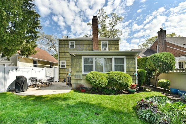 186 E Chester St, Valley Stream, NY 11580 - back of property with a patio and a chimney