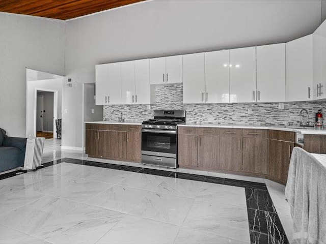 36 Starr Ave, Monticello, NY 12701 - kitchen with gas range, light countertops, a sink, wooden ceiling, and white cabinetry