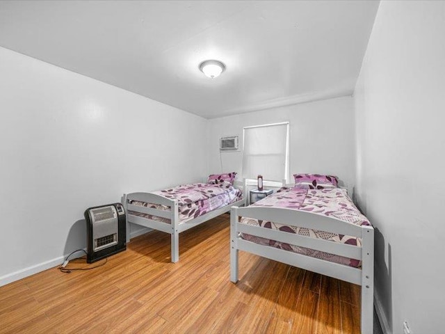 36 Starr Ave, Monticello, NY 12701 - bedroom with light wood finished floors, baseboards, and a wall mounted AC