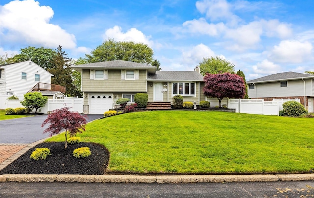 19 Walter Ct, Commack, NY 11725 - split level home with asphalt driveway, an attached garage, and a chimney