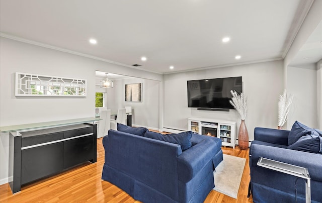 19 Walter Ct, Commack, NY 11725 - living room with ornamental molding, light wood finished floors, recessed lighting, a baseboard radiator, and a warm lit fireplace