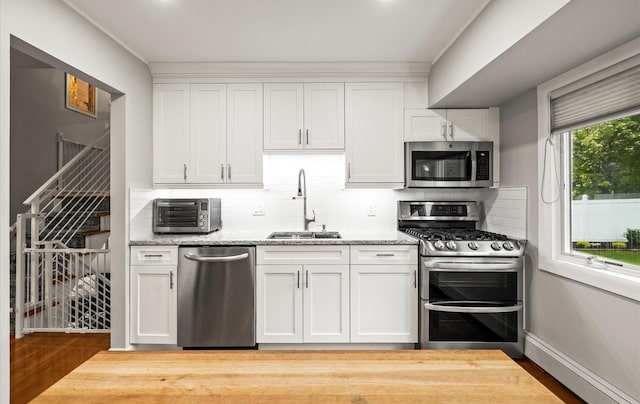 19 Walter Ct, Commack, NY 11725 - kitchen with stainless steel appliances, a sink, tasteful backsplash, white cabinets, and light stone counters
