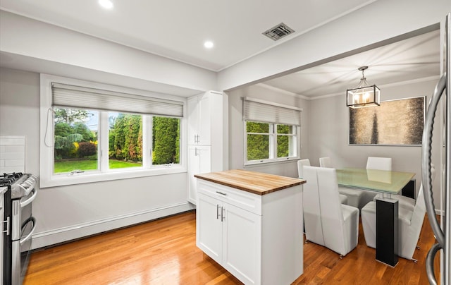 19 Walter Ct, Commack, NY 11725 - kitchen with butcher block counters, stainless steel appliances, white cabinetry, light wood finished floors, and a chandelier