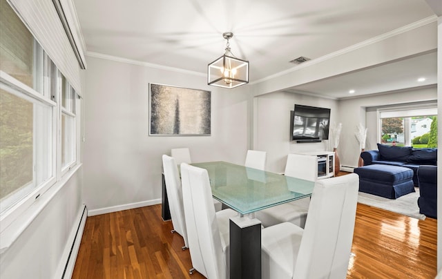 19 Walter Ct, Commack, NY 11725 - dining room with a baseboard heating unit, a chandelier, wood finished floors, ornamental molding, and baseboards