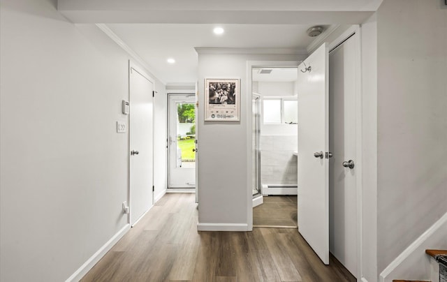19 Walter Ct, Commack, NY 11725 - foyer entrance with a baseboard heating unit, wood finished floors, ornamental molding, baseboards, and recessed lighting