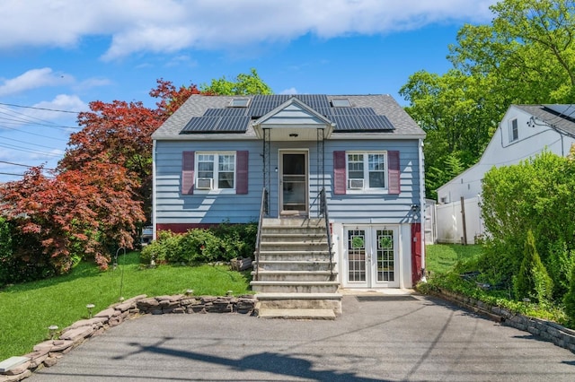 722 Shenandoah Ave, Peekskill, NY 10566 - view of front of property featuring roof mounted solar panels and roof with shingles