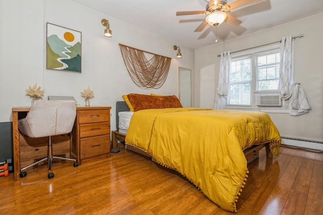 722 Shenandoah Ave, Peekskill, NY 10566 - bedroom featuring baseboard heating, hardwood / wood-style flooring, cooling unit, and a ceiling fan
