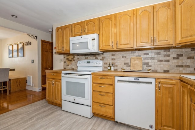 722 Shenandoah Ave, Peekskill, NY 10566 - kitchen featuring white appliances, light wood-type flooring, light countertops, and decorative backsplash