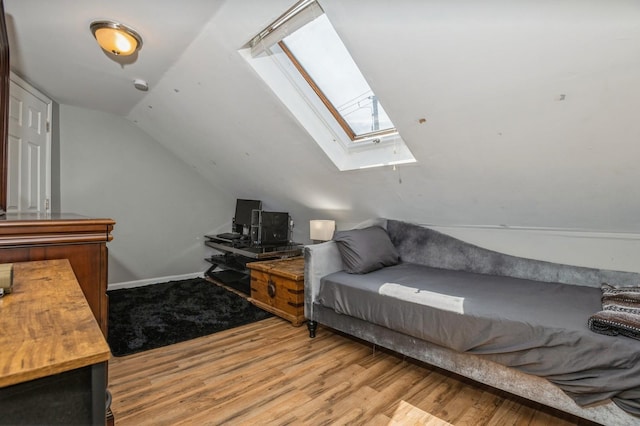 722 Shenandoah Ave, Peekskill, NY 10566 - bedroom featuring a skylight, vaulted ceiling, wood finished floors, and baseboards