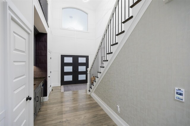 18 Heron Ct, Levittown, NY 11756 - entryway with stairs, wood finished floors, and a high ceiling