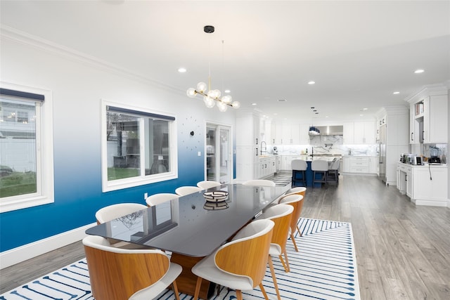 18 Heron Ct, Levittown, NY 11756 - dining space featuring light wood-style flooring, crown molding, a chandelier, recessed lighting, and baseboards