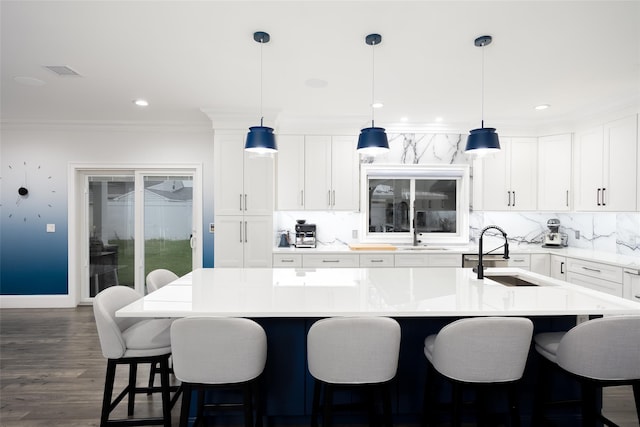 18 Heron Ct, Levittown, NY 11756 - kitchen featuring a sink, backsplash, a center island with sink, white cabinetry, and recessed lighting