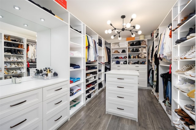 18 Heron Ct, Levittown, NY 11756 - walk in closet featuring dark wood-style floors and a chandelier