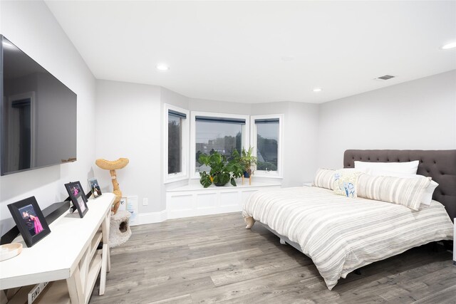 18 Heron Ct, Levittown, NY 11756 - bedroom with wood finished floors and recessed lighting