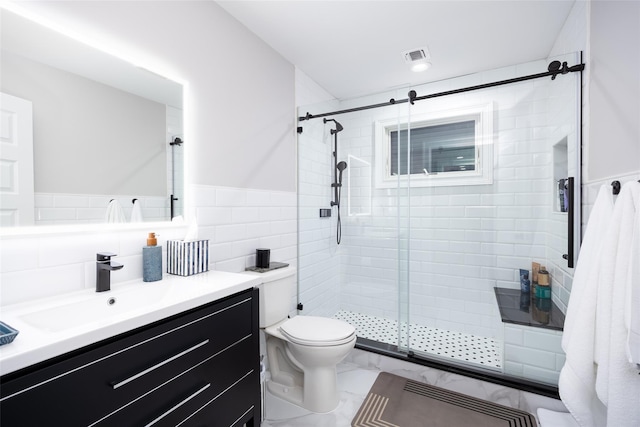 18 Heron Ct, Levittown, NY 11756 - full bathroom featuring a stall shower, toilet, vanity, a wainscoted wall, and tile walls