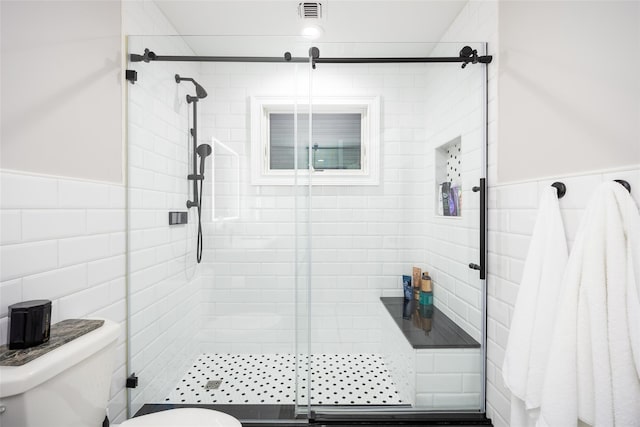 18 Heron Ct, Levittown, NY 11756 - full bathroom featuring toilet, a shower stall, tile walls, and a wainscoted wall