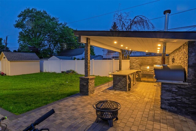 18 Heron Ct, Levittown, NY 11756 - view of patio with an outdoor kitchen, a fire pit, grilling area, a storage shed, and an outdoor bar