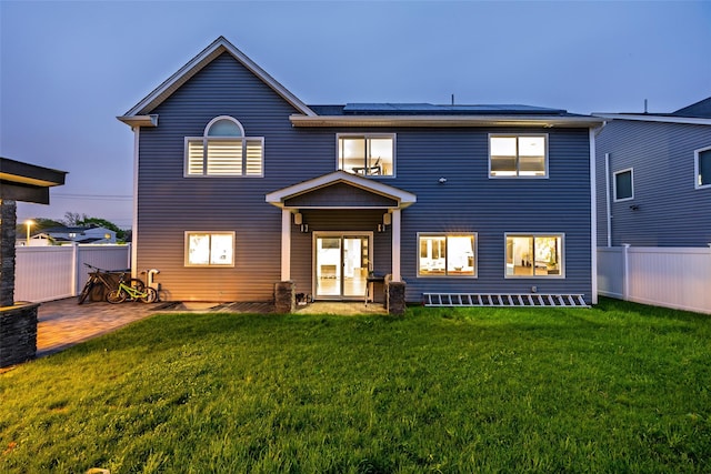 18 Heron Ct, Levittown, NY 11756 - rear view of house featuring solar panels and a patio