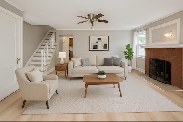 435 S Columbus Ave, Mount Vernon, NY 10553 - living room with wood finished floors, ceiling fan, stairs, a brick fireplace, and baseboards