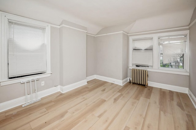 435 S Columbus Ave, Mount Vernon, NY 10553 - empty room with radiator, light wood-style floors, baseboards, and vaulted ceiling