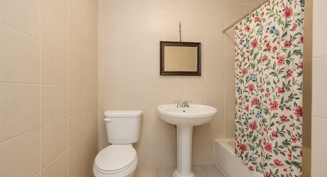 435 S Columbus Ave, Mount Vernon, NY 10553 - bathroom featuring tile walls, toilet, shower / bath combo, and a sink