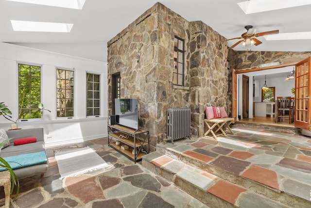 100 Mount Airy Rd S, Croton-On-Hudson, NY 10520 - living area featuring a skylight, radiator heating unit, vaulted ceiling, stone floors, and a ceiling fan