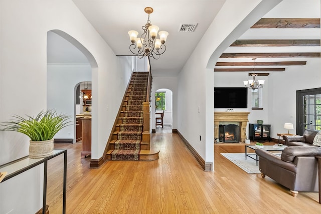 100 Mount Airy Rd S, Croton-On-Hudson, NY 10520 - living room featuring a chandelier, light wood-style floors, stairs, baseboards, and beamed ceiling