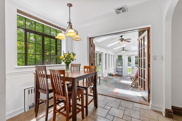 100 Mount Airy Rd S, Croton-On-Hudson, NY 10520 - dining area with arched walkways, crown molding, ceiling fan, stone tile flooring, and baseboards