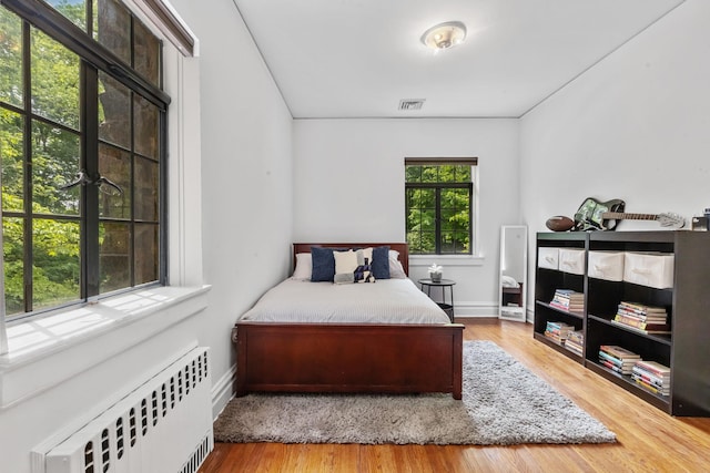100 Mount Airy Rd S, Croton-On-Hudson, NY 10520 - bedroom with radiator heating unit, wood finished floors, and baseboards