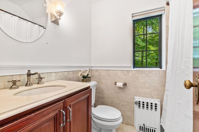 100 Mount Airy Rd S, Croton-On-Hudson, NY 10520 - full bathroom featuring radiator, tile walls, vanity, toilet, and a wainscoted wall