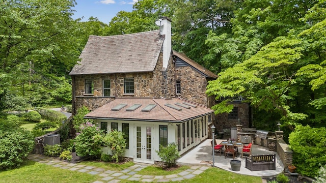 100 Mount Airy Rd S, Croton-On-Hudson, NY 10520 - rear view of house with french doors, area for grilling, stone siding, and a patio area