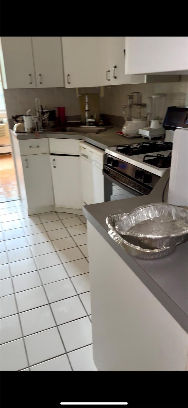 10 Ipswich Ave Unit 4M, Great Neck, NY 11021 - kitchen with gas stove, dishwasher, light tile patterned flooring, and white cabinetry