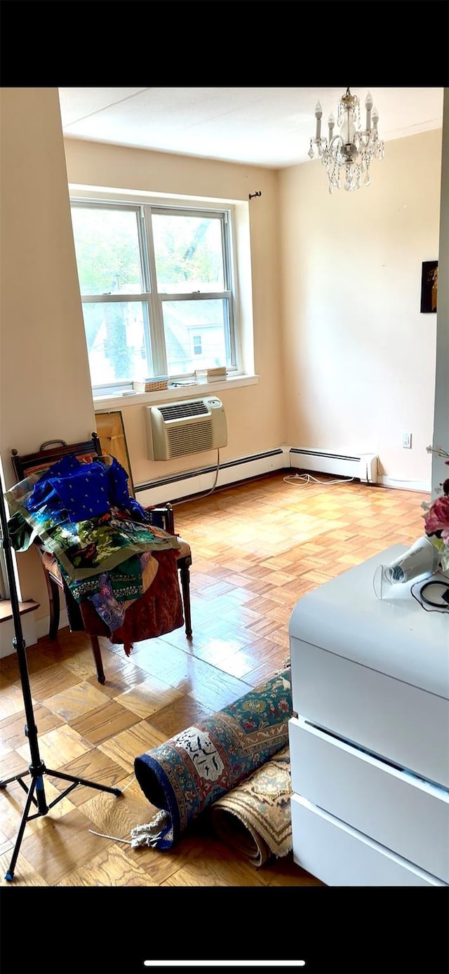 10 Ipswich Ave Unit 4M, Great Neck, NY 11021 - living area featuring a chandelier, a wall mounted air conditioner, and light wood finished floors