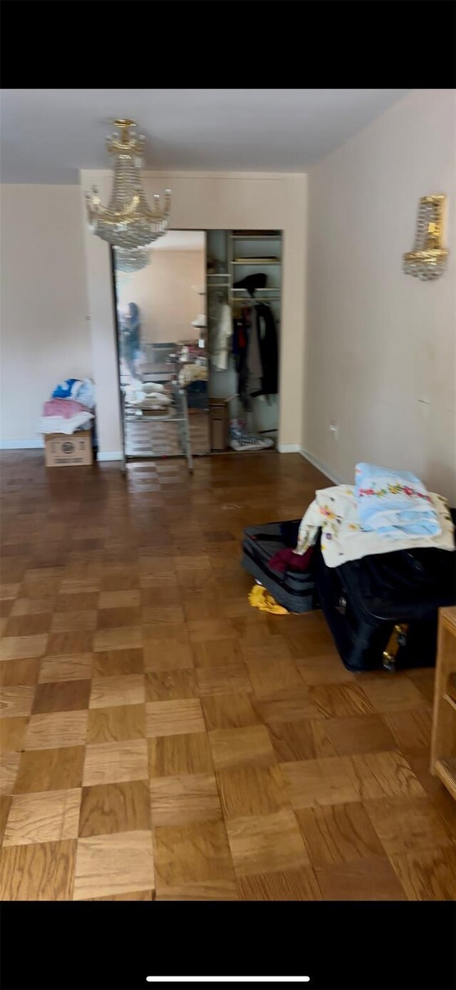 10 Ipswich Ave Unit 4M, Great Neck, NY 11021 - bedroom featuring a chandelier