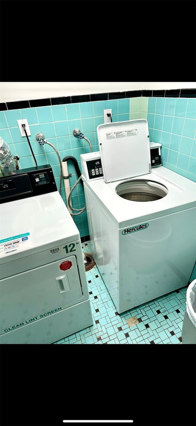 10 Ipswich Ave Unit 4M, Great Neck, NY 11021 - clothes washing area featuring tile walls and separate washer and dryer
