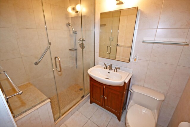 10 Ipswich Ave Unit 4M, Great Neck, NY 11021 - bathroom with vanity, a shower stall, tile walls, and tile patterned flooring