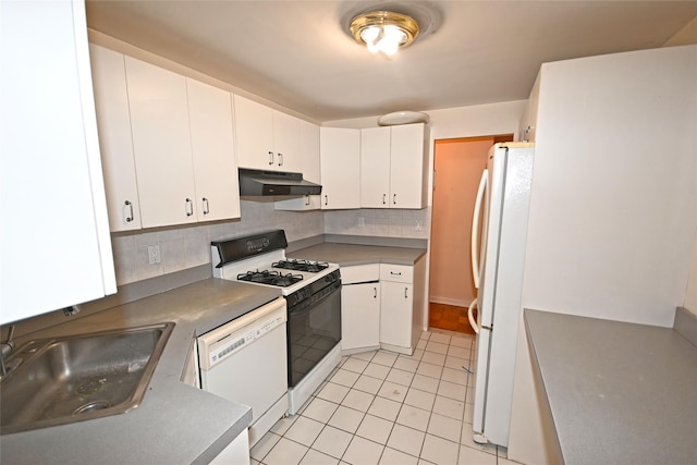 10 Ipswich Ave Unit 4M, Great Neck, NY 11021 - kitchen featuring white appliances, under cabinet range hood, light tile patterned floors, backsplash, and white cabinetry