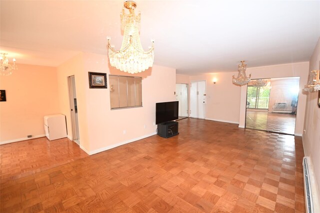 10 Ipswich Ave Unit 4M, Great Neck, NY 11021 - unfurnished living room with a chandelier and baseboard heating