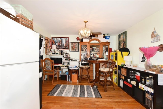 dining area featuring a chandelier and wood finished floors