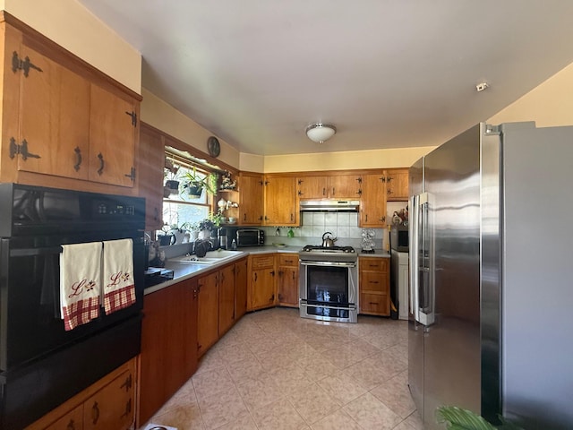 31 Stevenson Ave, Hartsdale, NY 10530 - kitchen featuring appliances with stainless steel finishes, under cabinet range hood, brown cabinets, decorative backsplash, and light countertops